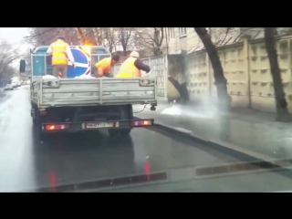 communal workers sprinkle salt on the pavement